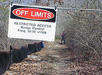 An Off Limits Restricted Access sign hangs across roadways that pose a threat to sensitive habitat