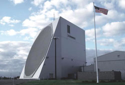 The large PAVE PAWS radar at the 6th Missle Early Warning Squadron stands tall against a bright blue sky. 